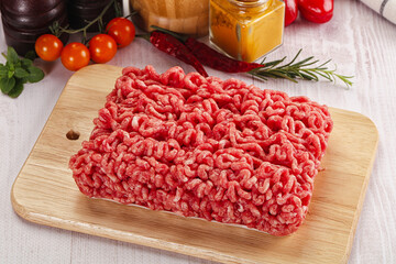 Raw minced beef meat over board