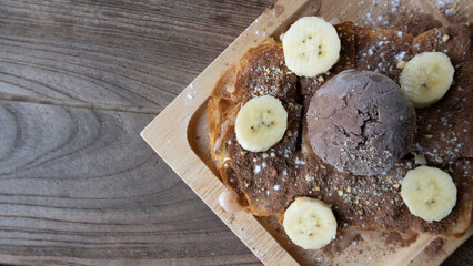 Banana split ice cream.A dessert with chocolate and banana.chocolate dessert on wooden plate