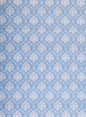 Old wallpaper on the wall. Old wallpaper for texture or background.