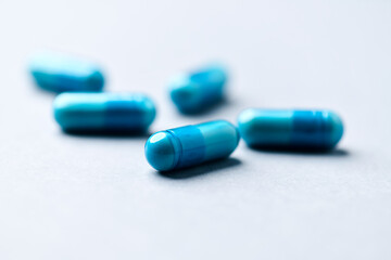 Amino acids capsules on paper background. Soft focus. Close up. Copy space.