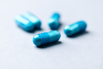 Amino acids capsules on paper background. Soft focus. Close up. Copy space.