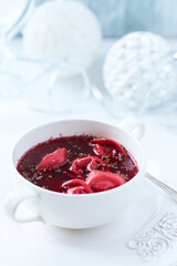 Traditional Christmas Borscht (Barszcz) with mushroom dumplings on bright background.	