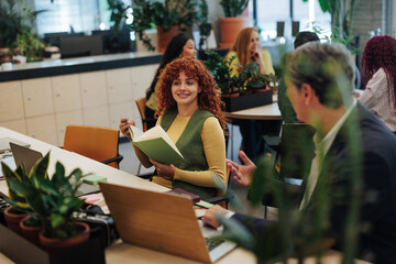 Managers discussing business strategy in modern green office