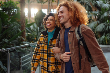 Happy tourists couple walking and smiling in train station in madrid