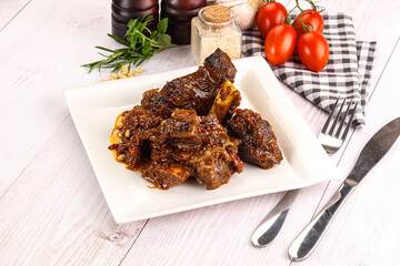 Prepared tasty beef ribs with sauce
