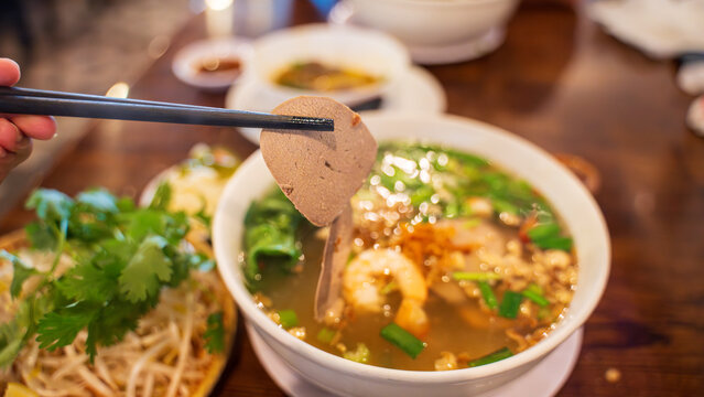 Hu tieu nam vang or Vietnamese pork and prawn soup with clear noodles. A customized noodle soup from Pnom Penh, Cambodia. White noodles and broth are topped with cooked pork liver, intestine, minced 