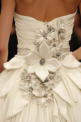 Elegant bridal gown featuring floral embellishments, back view