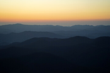 Silhouette of a mountain range with a red sunset in the background