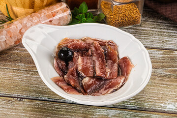 Canned anchovy with oil in the bowl