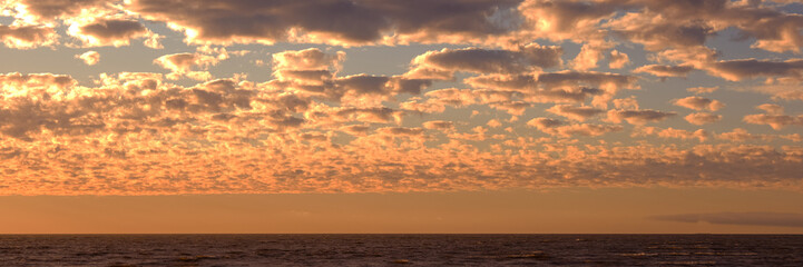 Dramatic sunset sky with pink and orange clouds. Natural background.