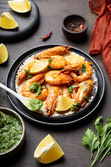  Fried shrimps with lemon and green in a plate vertical photo