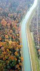 View from above of the Isar. Autumn, foggy and cloudy. Green water and the forest in autumn
