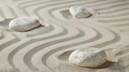 Obraz premium photo of three white stones on white sand, isolated on clear background
