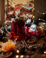 Christmas card: tea, and festive decor. The warm colours of cinnamon and dried oranges, with a cozy spirit, fill the background with wonder for your holiday story. Magical Christmas tale. 