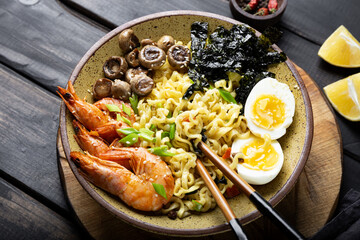  Asian ramen with shrimp, mushrooms, egg and greens close up