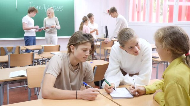 Schoolchildren study together in group lessons in the school class