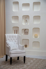 Modern cozy interior with a white armchair in vintage style