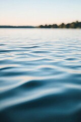 Calm water surface reflecting soft light and gentle waves.