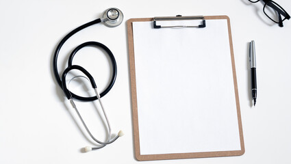 Top view of doctor office work with stethoscope, laptop and clipbroad with copy space for your text.