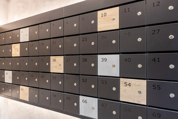 Many post boxes in modern apartment building. Postage boxes in an apartment complex.