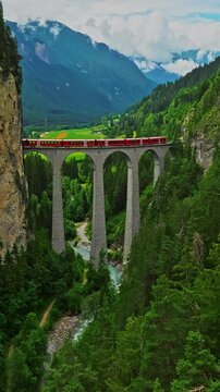 Aerial view Landwasser Viaduct world and Bernina express summer scenery. Railway scenic route in Switzerland