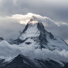 Mountain landscape: snow-capped peak, clouds around, snow