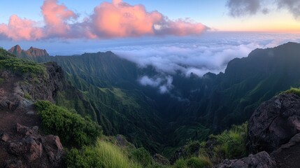 Fototapeta premium A stunning panoramic view of lush mountains and clouds at sunset.