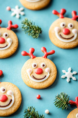 Delightful Christmas shortbread cookies shaped like reindeer with cheerful decorations on a vibrant blue background