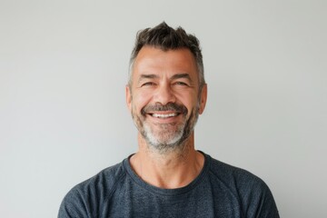 Fototapeta premium Portrait of a happy caucasian man in his 40s donning a trendy cropped top over white background