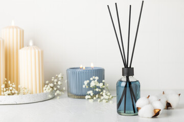 Aromatic reed air freshener on wooden table.Diffuser with natural fruity, floral, spicy aroma.interior scent. Luxury perfume for the home.Orange, lime, coffee, cinnamon, star anise, vanilla and orchid