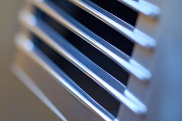 A close-up shot of a metal vent on a wall, suitable for use in various interior design and architecture projects