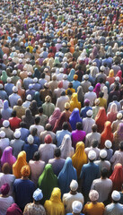 Fototapeta premium large prayer gathering with diverse attendees wearing colorful attire and head coverings, showcasing unity and devotion in vibrant atmosphere