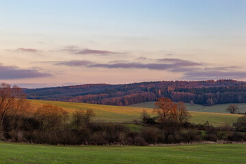 The evening sky over fields and forests. The last day of autumn.