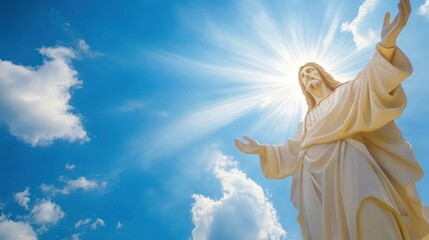 Statue of Jesus with radiant light under blue sky