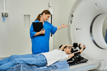 Fototapeta premium Doctor discusses MRI scanning process with patient lying in machine as part of diagnostics.
