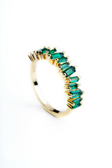 golden ring with translucent green stones