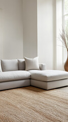 Minimalist living room with a sleek gray sectional, a woven area rug, and minimal decorative objects
