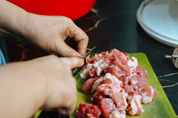 close-up of meat being cut on a cutting board