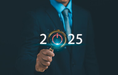 Business goals and vision for 2025, performance target for success Concept, businessman holding magnifying glass at text 2025 for business start up, strategy and process for annual business plan