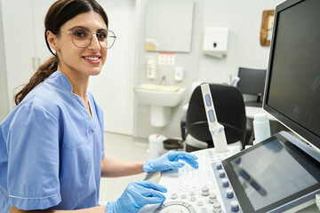 Dedicated professional actively conducting female health diagnostics in a well-equipped clinic.