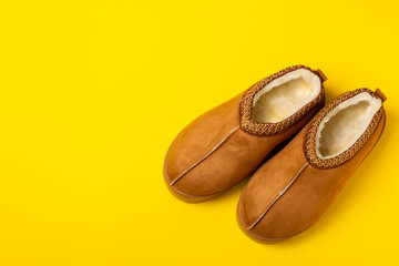 Soft slippers on a bright colored background, close-up. House slippers. Comfortable shoes for home. Foot care concept. Home comfort. Space for text. Copy space.