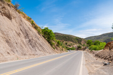 A road surrounded by mountains in a natural setting