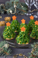 Festive snack in form of Christmas tree made of cheese, boiled eggs, parsley and carrot stars