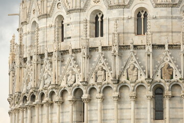 Romanesque architecture. Gothic marble decorations.Pisa Baptistery in Pisan Romanesque style, built in white Carrara marble with sculptures. Italy