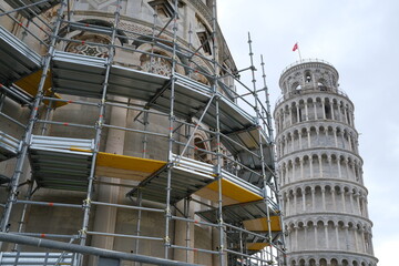 Restoration site. Scaffolding and Tower of Pisa.Restoration work on a historic building in Pisan Romanesque style in Piazza dei Miracoli.  Italy