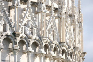 Romanesque architecture. Gothic marble decorations.Pisa Baptistery in Pisan Romanesque style, built in white Carrara marble with sculptures. Italy