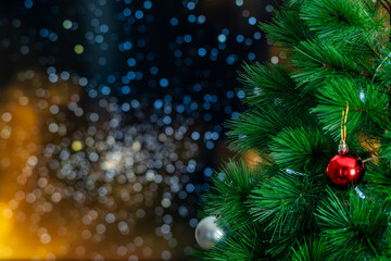 Close up view of fir branches with shiny ball Christmas holidays background. copy space. Decoration on christmas tree in Christmas Festive and Happy New Year