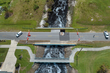 Police car roadblock at damaged road bridge destroyed by river after flood water washed away...