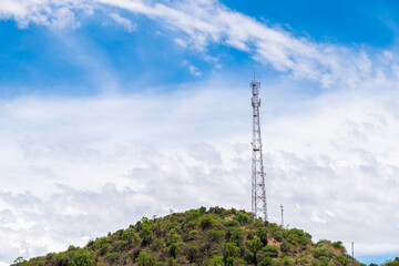 Radio, communication and cell towers on blue sky background