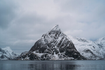 Snowy mountain peaks rising from the sea in lofoten islands, norway